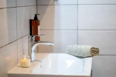 a bathroom sink with a candle next to it at BonAire apartment in Kranjska Gora