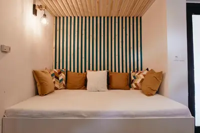 a bed with pillows on it in a room at AVA HOUSE in Kranjska Gora
