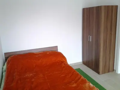 a bedroom with a bed with a wooden cabinet at Izzi apartma in Kranjska Gora