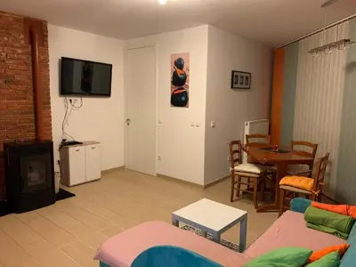 a living room with a couch and a table at Izzi apartma in Kranjska Gora