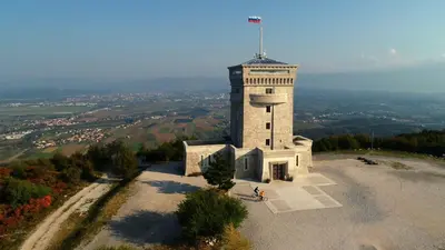 a building with a flag on top of it at Vila Brinovka in Kostanjevica na Krasu