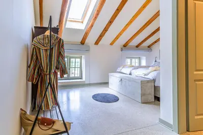 a room with a bed and a ladder in it at Vila Brinovka in Kostanjevica na Krasu