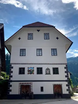 a large white building with stars on it at Juvanova hiša (all house) in Luče