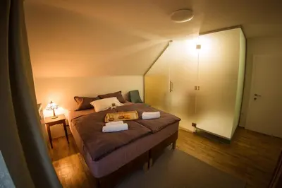 a bedroom with a bed with a tray on it at Vila Park Ravne in Ravne na Koroškem