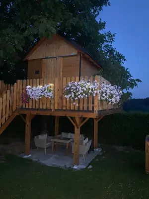 a wooden gazebo with flowers on it at Villa DonLeone in Ponikva