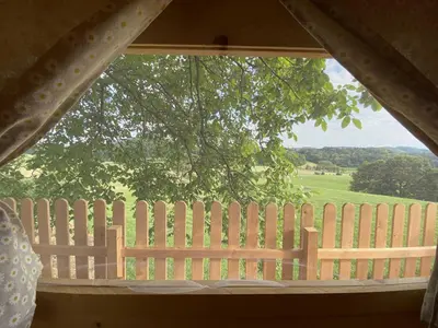 a window with a fence and a view of a field at Villa DonLeone in Ponikva
