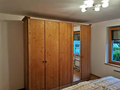 a bedroom with a wooden closet and a bed at Apartma Lana in Mojstrana