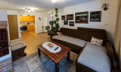 a living room with a couch and a table at Apartma Lana in Mojstrana