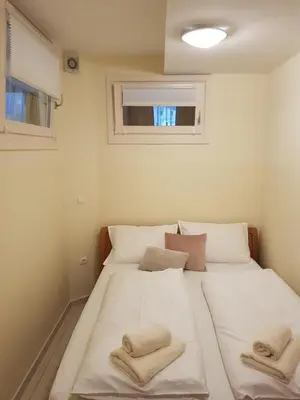 a bedroom with a large white bed with towels on it at Apartment Ranc in Kranjska Gora