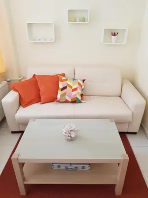 a living room with a white couch and a coffee table at Apartment Ranc in Kranjska Gora