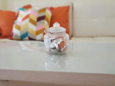 a glass jar filled with candy on a table at Apartment Ranc in Kranjska Gora