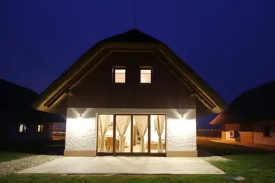 a barn at night with the doors open at Panonska Vas Apartments in Moravske Toplice