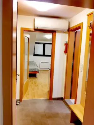 a hallway leading to a room with a bed at Apartma Happy in Kranjska Gora