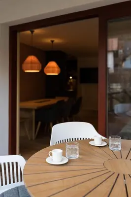 a wooden table with white cups and saucers on it at Our Second Home in Kranjska Gora in Kranjska Gora