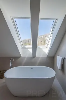 a white bath tub in a bathroom with skylights at Our Second Home in Kranjska Gora in Kranjska Gora