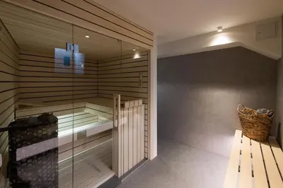 a walk in shower in a room with a bench at Our Second Home in Kranjska Gora in Kranjska Gora