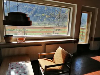 a window in a room with a table and a chair at House Nordika in Rateče