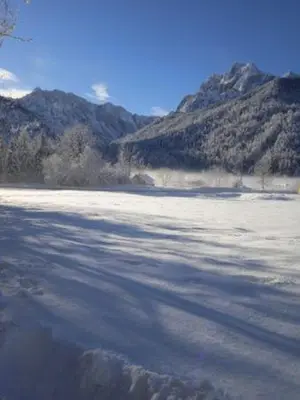 a large body of water with mountains in the background at House Nordika in Rateče