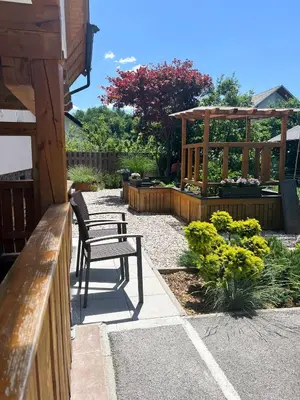 a patio with two chairs and a gazebo at Lovely basement rental in Bled