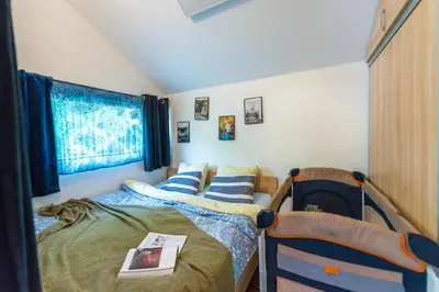 a bedroom with two twin beds and a window at Boho House 3 camp Terme Catez with promotional tickets prices in Čatež ob Savi