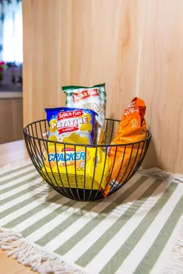 a basket of chips and other snacks on a table at Boho House 3 camp Terme Catez with promotional tickets prices in Čatež ob Savi