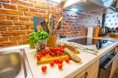 a kitchen counter with tomatoes on a cutting board at Boho House 3 camp Terme Catez with promotional tickets prices in Čatež ob Savi