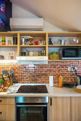 a kitchen with a brick wall and a stove at Boho House 3 camp Terme Catez with promotional tickets prices in Čatež ob Savi