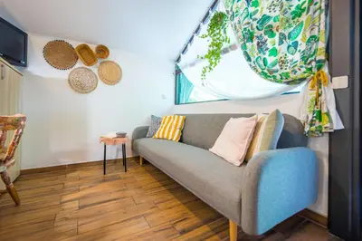 a living room with a couch and a window at Boho House 3 camp Terme Catez with promotional tickets prices in Čatež ob Savi