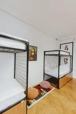 a room with two bunk beds in a attic at Party Hostel Zzz in Ljubljana