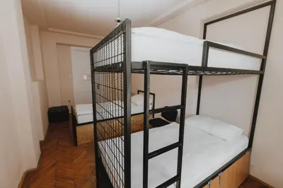 a room with two bunk beds and a mirror at Party Hostel Zzz in Ljubljana