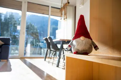 a stuffed gnome toy sitting on a counter in a room at Pohorje Fox duplex apartment in Maribor