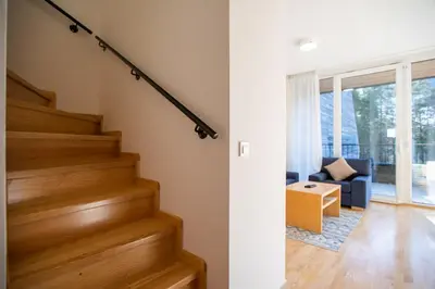 a staircase in a house with a living room at Pohorje Fox duplex apartment in Maribor