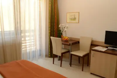 a bedroom with a desk with a computer and two chairs at Vila Park B&B - Adults Only in Bohinj