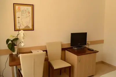 a room with a desk with a computer and two chairs at Vila Park B&B - Adults Only in Bohinj