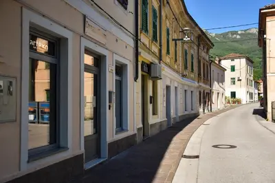 an empty street in a town with buildings at Apartma Darsi in Ajdovščina