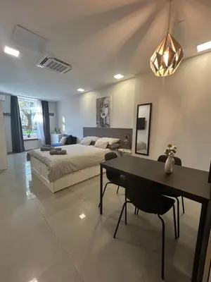 a bedroom with a bed and a table and chairs at Apartma Darsi in Ajdovščina