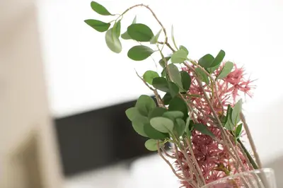 a glass vase with a bunch of flowers in it at Cozy apartments in Ljubljana