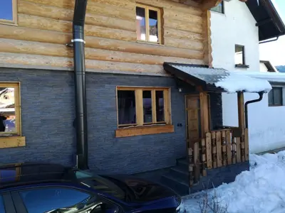 a house with a car parked in front of it at LES CHALET Kranjska Gora I in Kranjska Gora