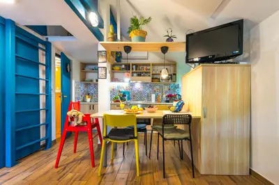 a kitchen with a table and chairs and a tv at Boho House 4 camp Terme Catez with promotional tickets prices in Čatež ob Savi