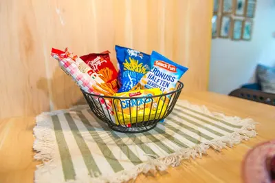 a basket of chips and other snacks on a table at Boho House 4 camp Terme Catez with promotional tickets prices in Čatež ob Savi