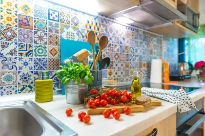 a kitchen counter with tomatoes on a cutting board next to a sink at Boho House 4 camp Terme Catez with promotional tickets prices in Čatež ob Savi