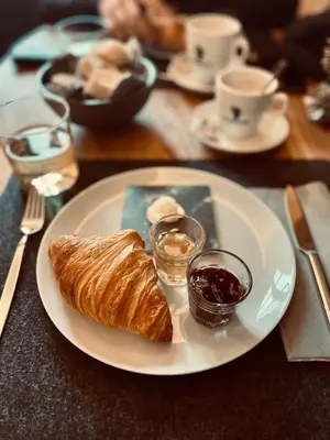 a plate of croissants and jam on a table at Hotel Pino Alpino in Kranjska Gora