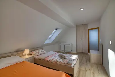 a small bedroom with two beds and a window at Farmhouse Raspberry Pool&Wellness - Happy Rentals in Vransko