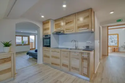 a kitchen with wooden cabinets and a sink at Farmhouse Raspberry Pool&Wellness - Happy Rentals in Vransko