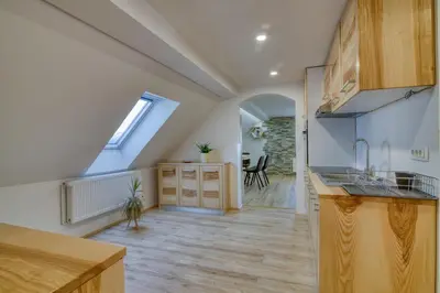 an attic kitchen with a skylight and a dining room at Farmhouse Raspberry Pool&Wellness - Happy Rentals in Vransko