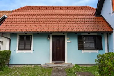 a blue house with an orange roof at Spa House Blue Lagoon in Terme Čatež in Čatež ob Savi