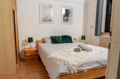a bedroom with a bed with green pillows on it at Spa House Blue Lagoon in Terme Čatež in Čatež ob Savi