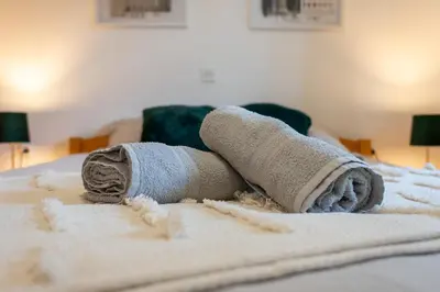 a pair of rolled up towels on a bed at Spa House Blue Lagoon in Terme Čatež in Čatež ob Savi