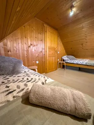 a bedroom with a bed in a wooden cabin at Spa House Blue Lagoon in Terme Čatež in Čatež ob Savi