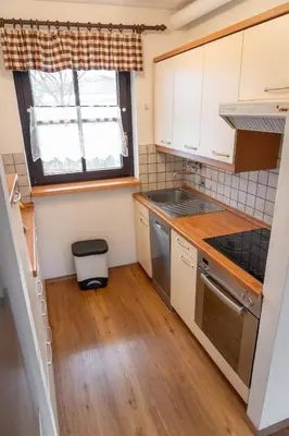 a small kitchen with white cabinets and a window at Spa House Blue Lagoon in Terme Čatež in Čatež ob Savi